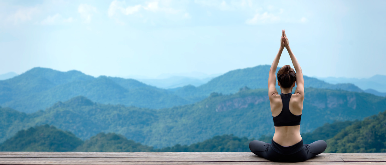 Unlocking the Power of Mind-Body Practices for Improved Brain Health An image of a person meditating with their eyes closed, surrounded by greenery and natural scenery. This image represents the power of mind-body practices in improving brain health and cognitive function.